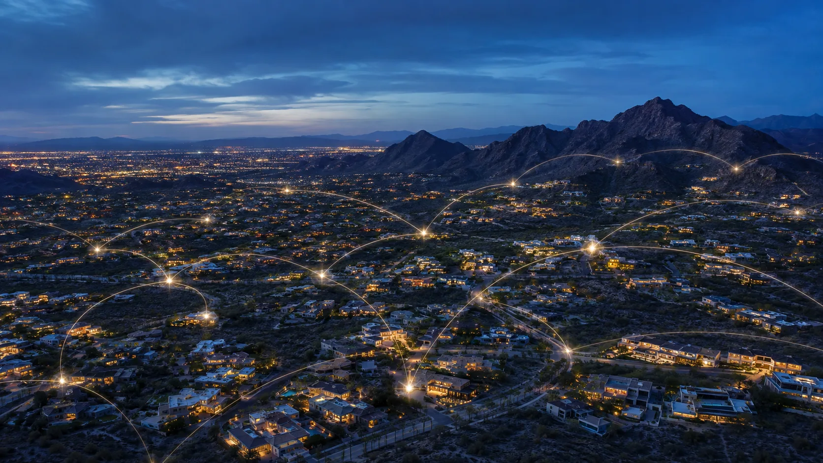 Night aerial view of an Arizona desert community with glowing gold connection lines linking homes across the valley